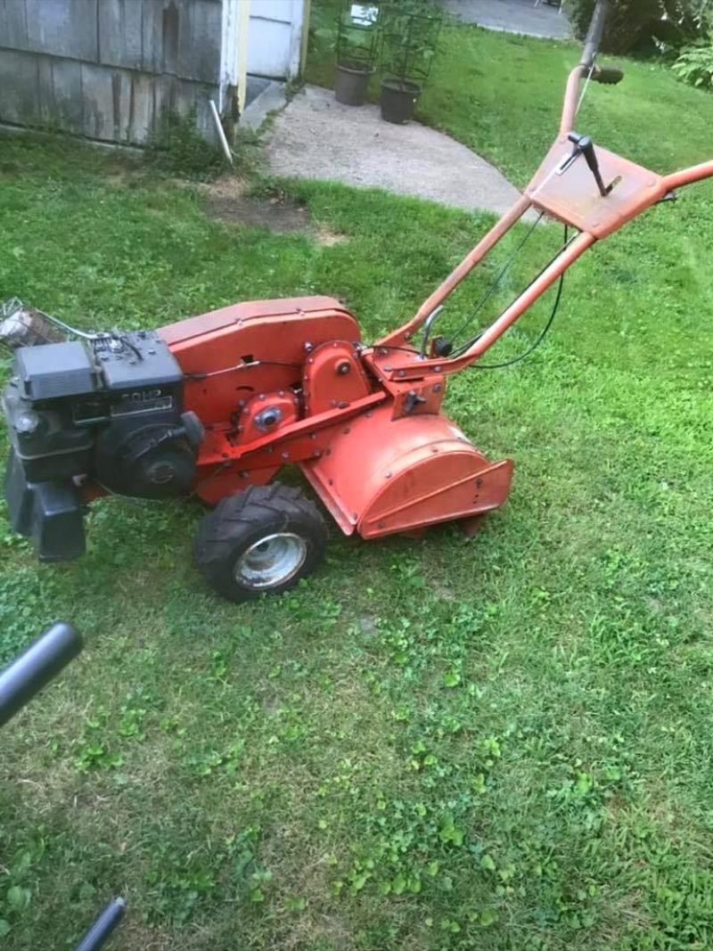 Orange rear-tine tiller.
